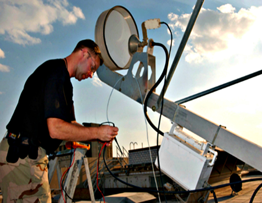 050203-F-1631A-002
Technical Sergeant Paul Hendrix, a video intrusion detection system technician from Charleston AFB, South Carolina, tests line voltages to varify the strength of the satellite signal being received.  This satellite system is the JCCITSS hub which receives combat camera imagery from various field units throughout Iraq.  
USAF Photo by MSgt Dave Ahlschwede  (Released)